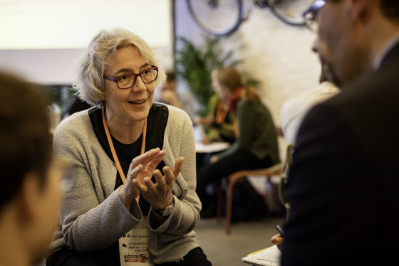 Eine Frau erklärt einem Zuhörer etwas